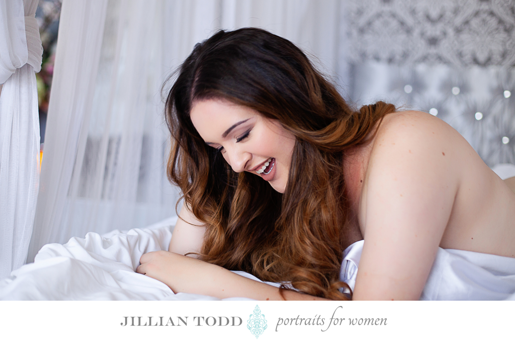 woman laughing and looking sexy in a white sheet