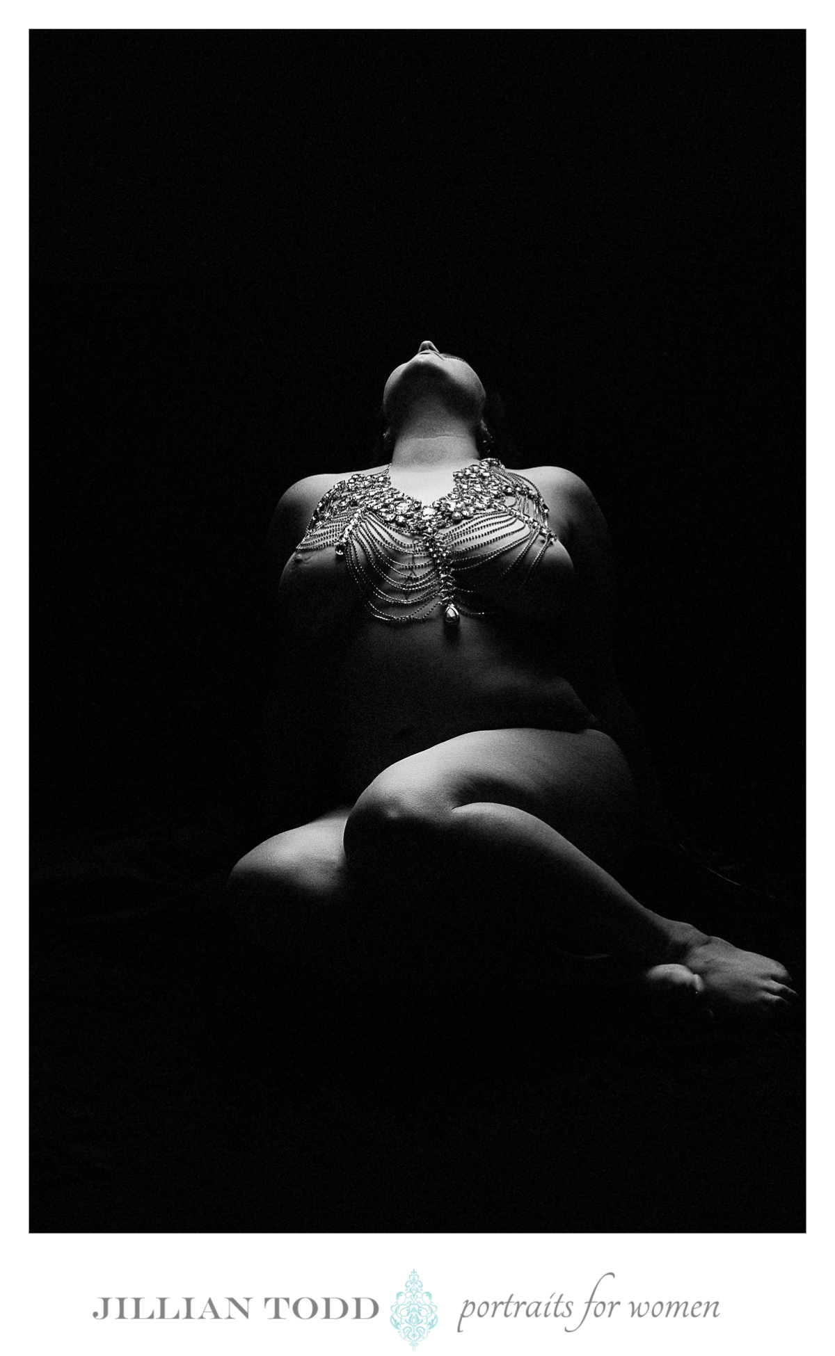 black and white mysterious photo of nude woman with extravagant body jewelry
